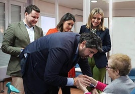 El presidente del Gobierno regional, Fernando López Miras, saluda a una residente de un centro de personas mayores en presencia de la consejera de Política Social, Familias e Igualdad, Conchita Ruiz.