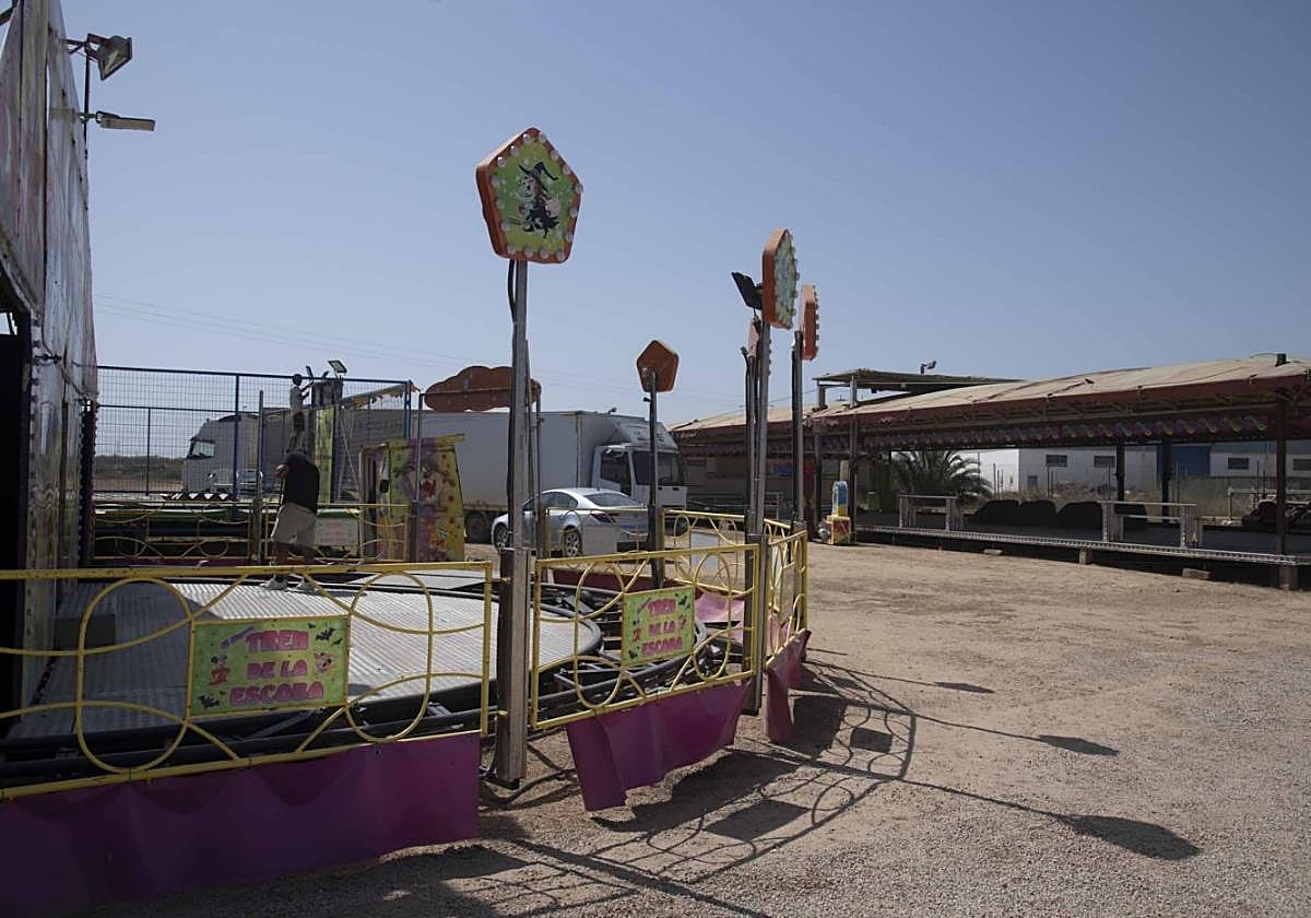 Un feriante se prepara para abrir su atracción tras la concesión del permiso por la Comunidad.