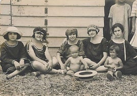 Bañistas en la puerta de una barraca de la playa de La Isla, en una fotografía de la exposición 'Álbum de estío'.