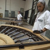 Mara Noguera, al fondo, y Montse Pasqual del Riquelme trabajan en la rejería de plomo de las puertas de entrada.