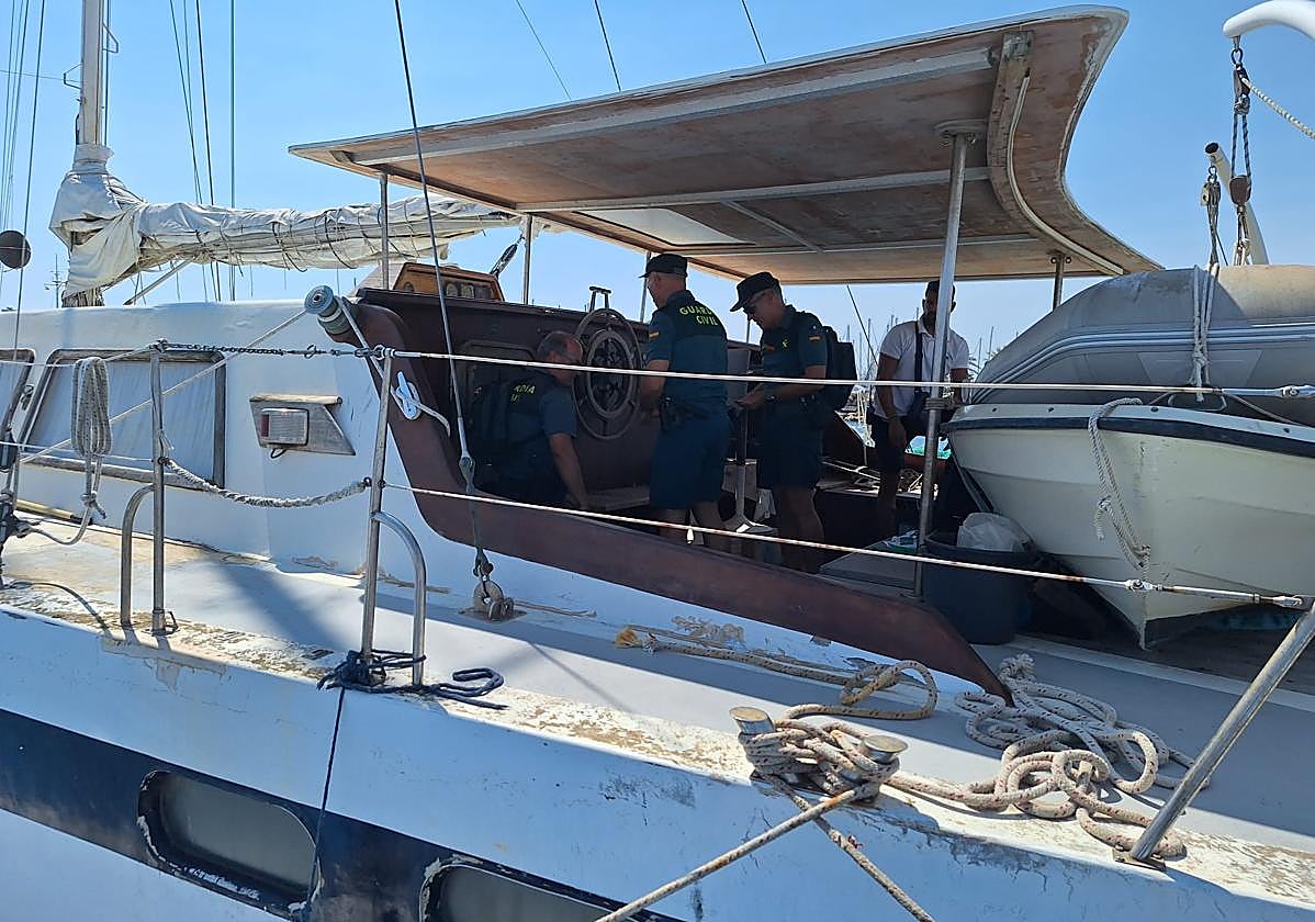 Guardias civiles, ayer inspeccionando el catamarán en Santiago de la Ribera.