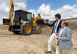 El consejero Jorge García Montoro, junto a la maquinaria, durante su visita en la carretera RM-313.