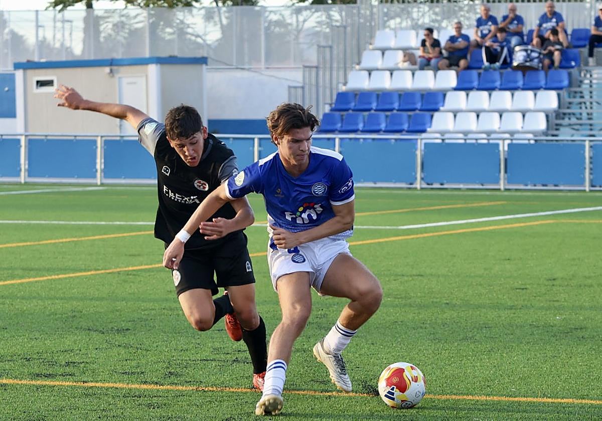 Junior (Molinense) controla el balón ante la presión rival.