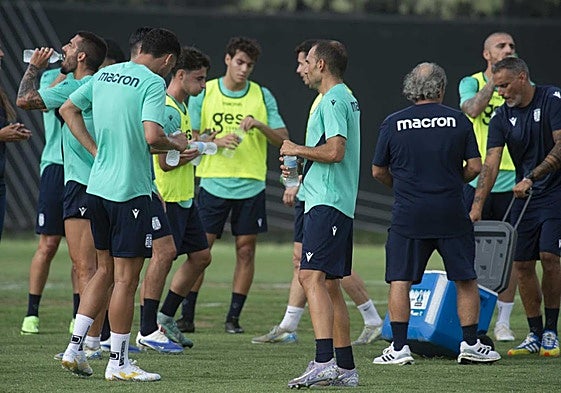 Los jugadores del Efesé hacen una pausa para refrescarse durante un entrenamiento.