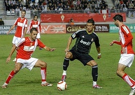 Cristiano Ronaldo intenta marcharse de dos defensores granas como Luciano y Albiol en la visita del Real Madrid al Enrique Roca en octubre de 2010, partido que acabó 0-0.