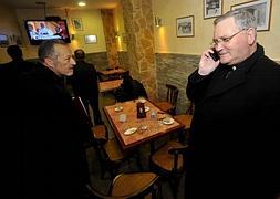 Lorca Planes (d.) habla por teléfono en un bar de Cartagena, donde ha conocido el nombre del nuevo Papa. :: Antonio Gil/AGM