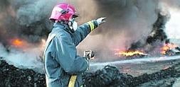 Un bombero trabajando ayer en la extinción del incendio en la planta de reciclaje de neumáticos de Ceutí. ::                             PEPE BREIS