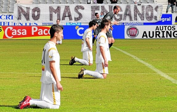 Los jugadores del Real Jaén pidiendo de rodillas la marcha del entonces primer accionista del club.