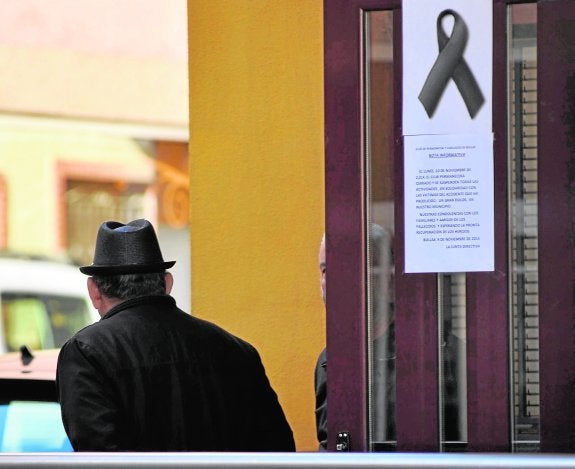 Un crespón negro en señal de duelo en la puerta del centro de mayores; el símbolo se repite por toda la localidad.