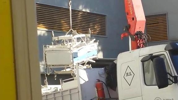 Un camión saca una de las camas del Rosell y la carga en su parte posterior.