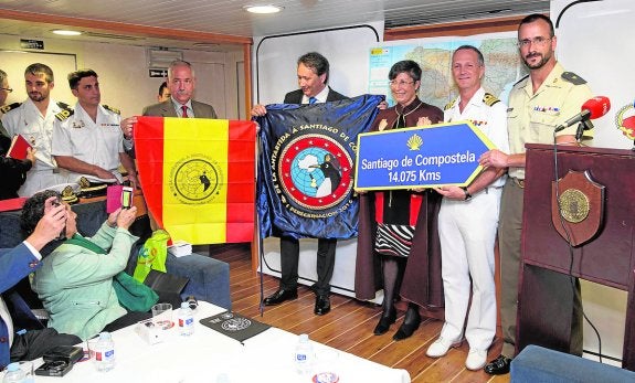 Militares y directivos de la Federación, con las insignias y el cartel de inicio de la nueva ruta. 