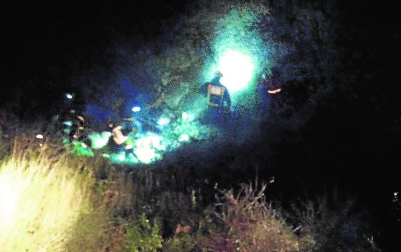 Personal de emergencias, en el fondo del barranco, rescatando el cadáver de Rogelio.  