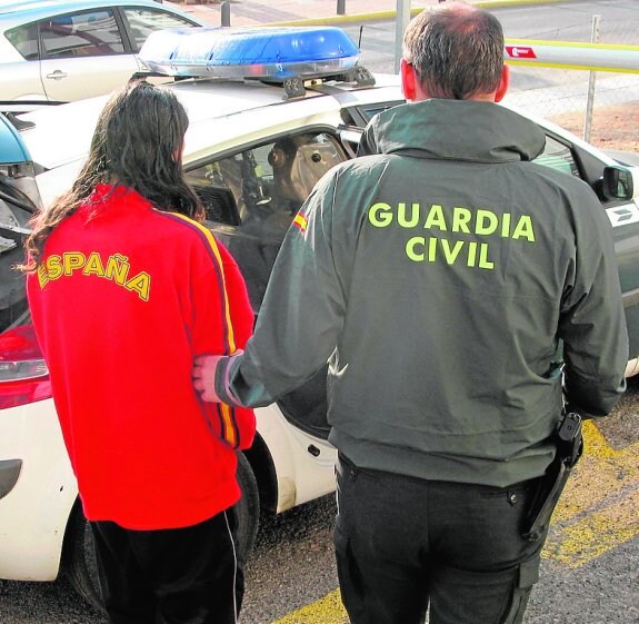 Uno de los detenidos, custodiado por un agente de la Benemérita.
