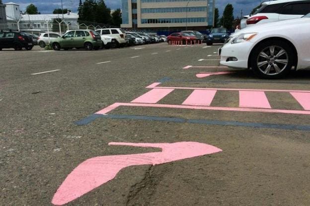 Un parking ruso con un zapato de tacón rosa para señalizar las plazas. 