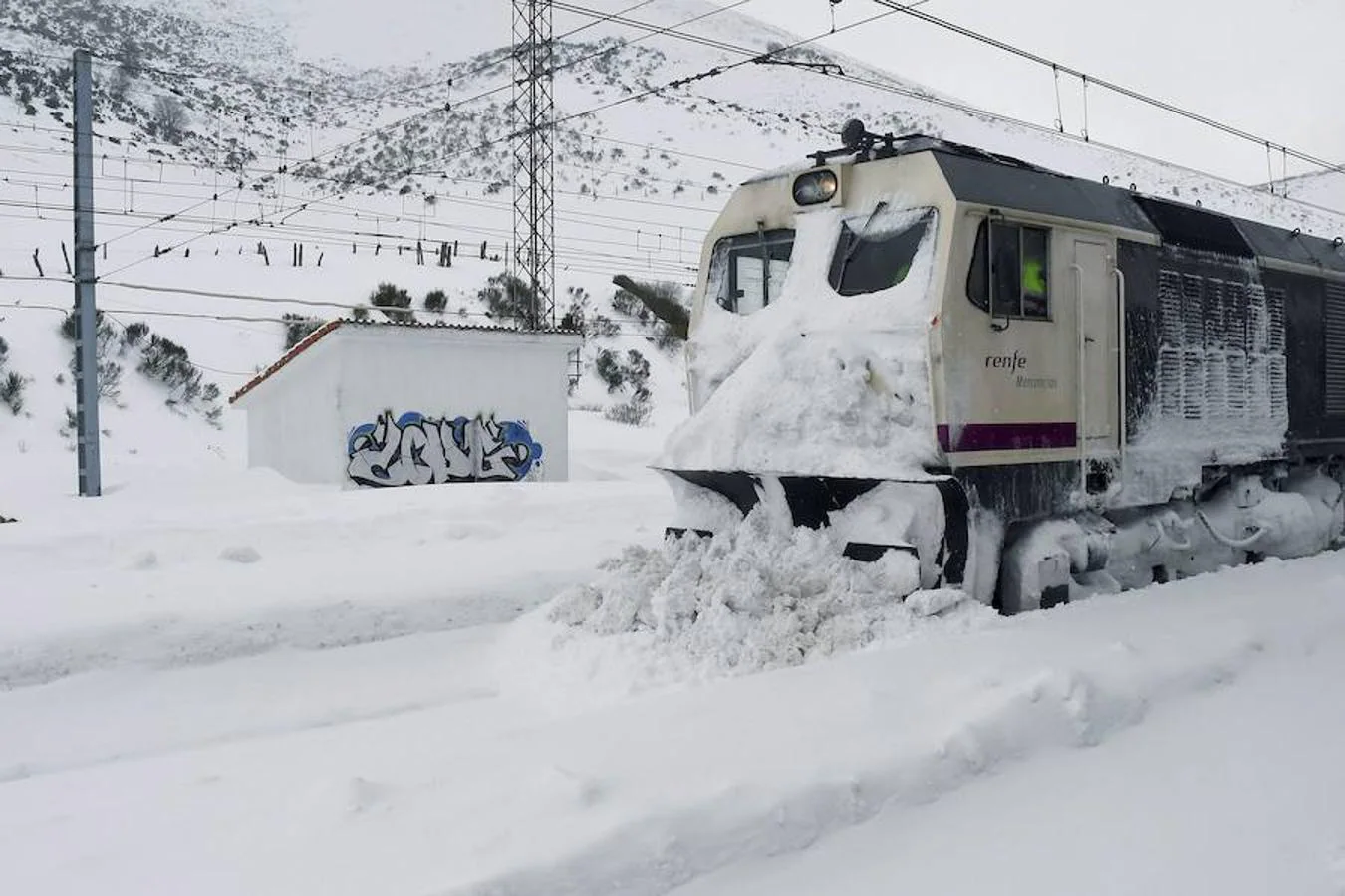 La vía férrea que une León y Asturias, afectada por la nieve. En la imagen, un tren parado en la estación de Busdongo (León) || La nieve frena al tren en el Puerto de Pajares. Las intensas nevdas están frenando en seco el tráfico ferroviario