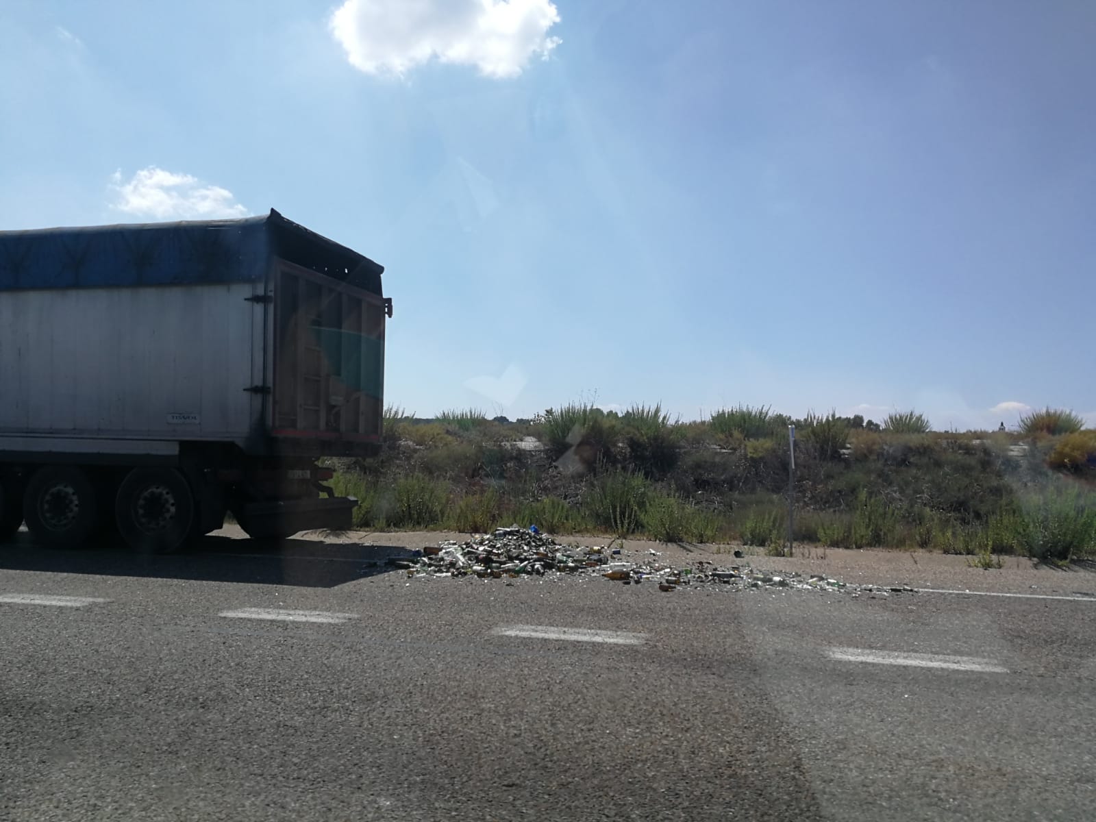 Imagen de la carga volcada en la calzada. 