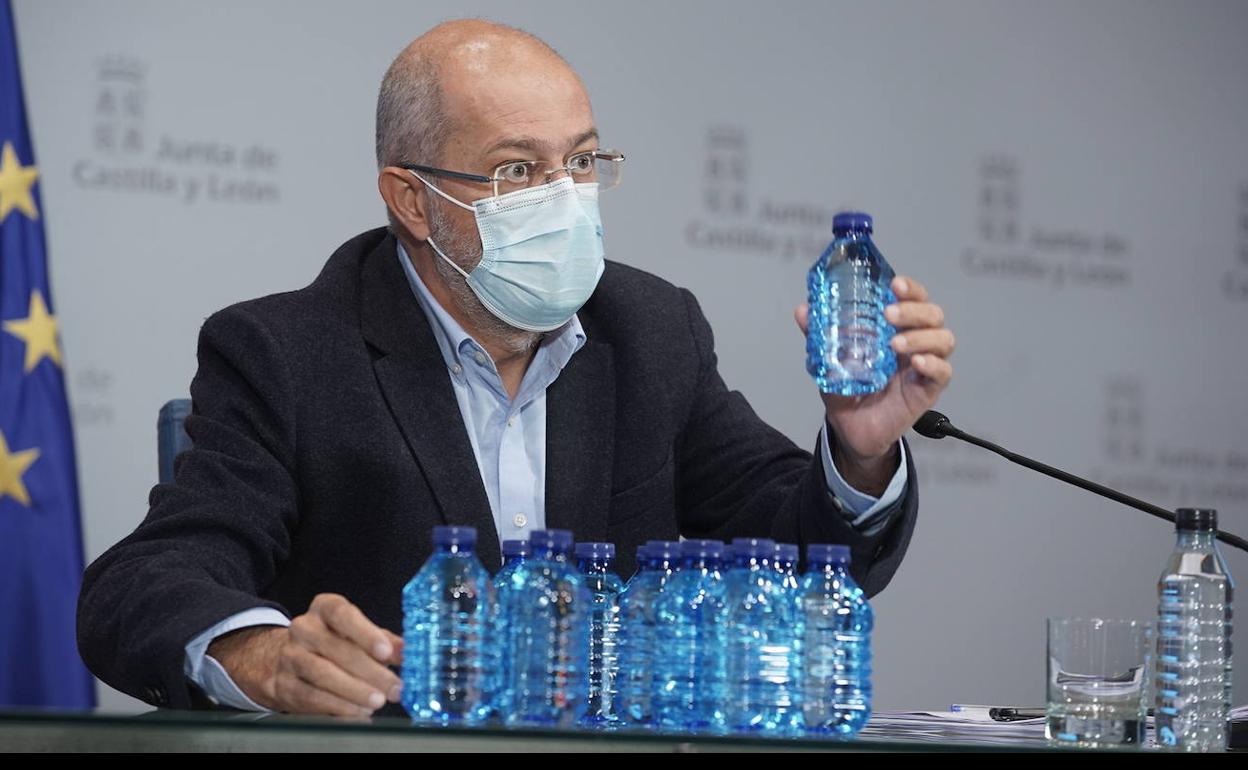 Igea utiliza las botellas de agua de la sala de prensa para explicar la vacunación. 