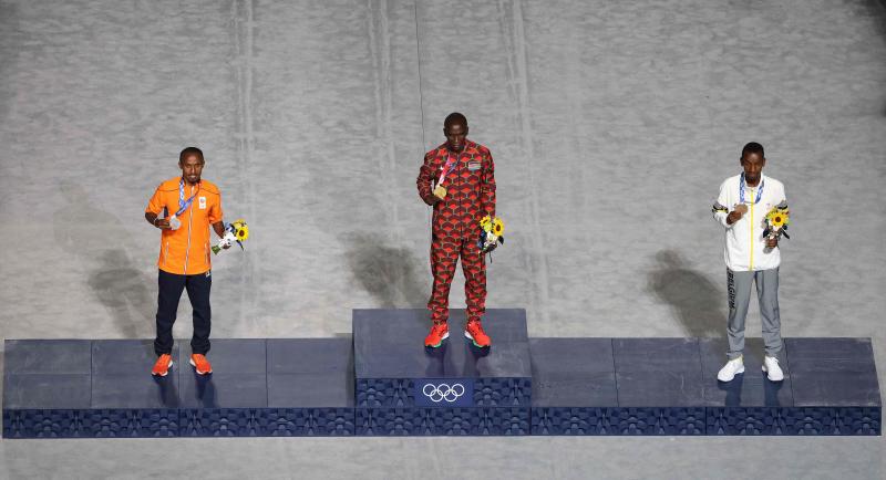 Salen los seis galardonados en categorías femenina y masculina de maratón para recibir las medallas sobre el cajón.