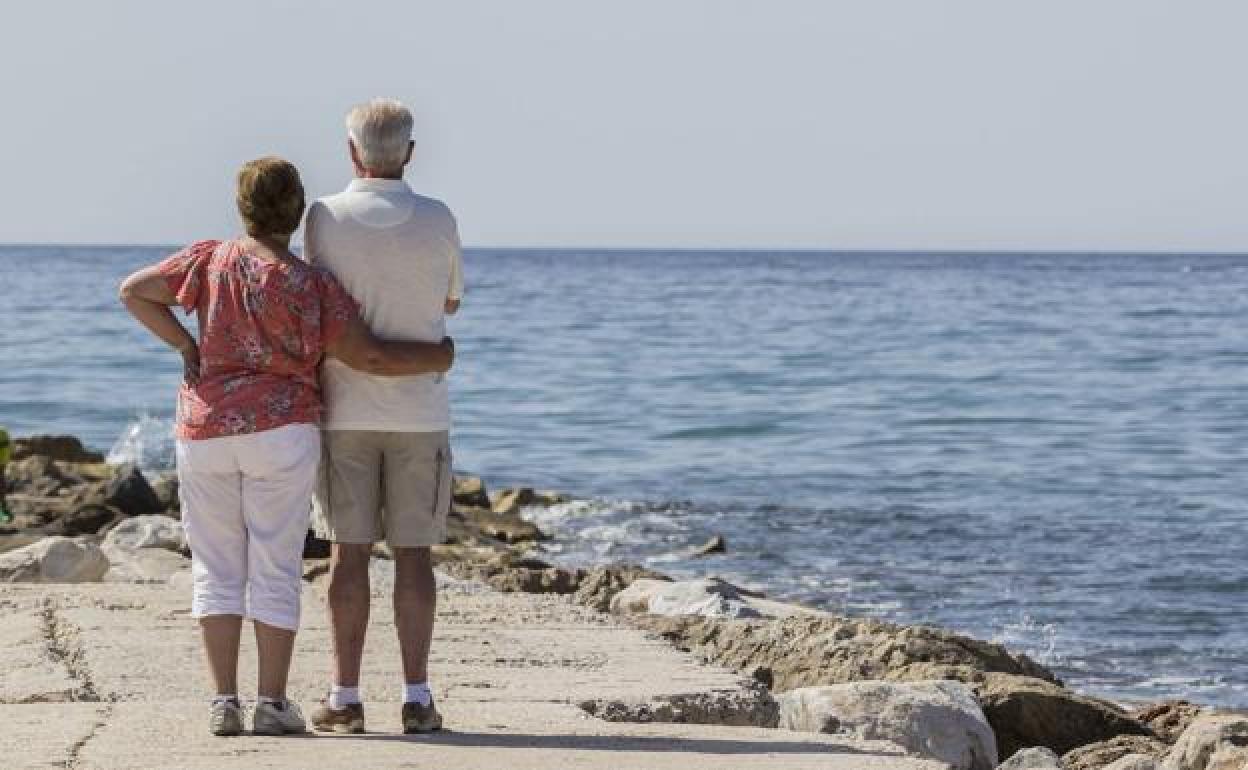 Una pareja de jubilados observa el mar.