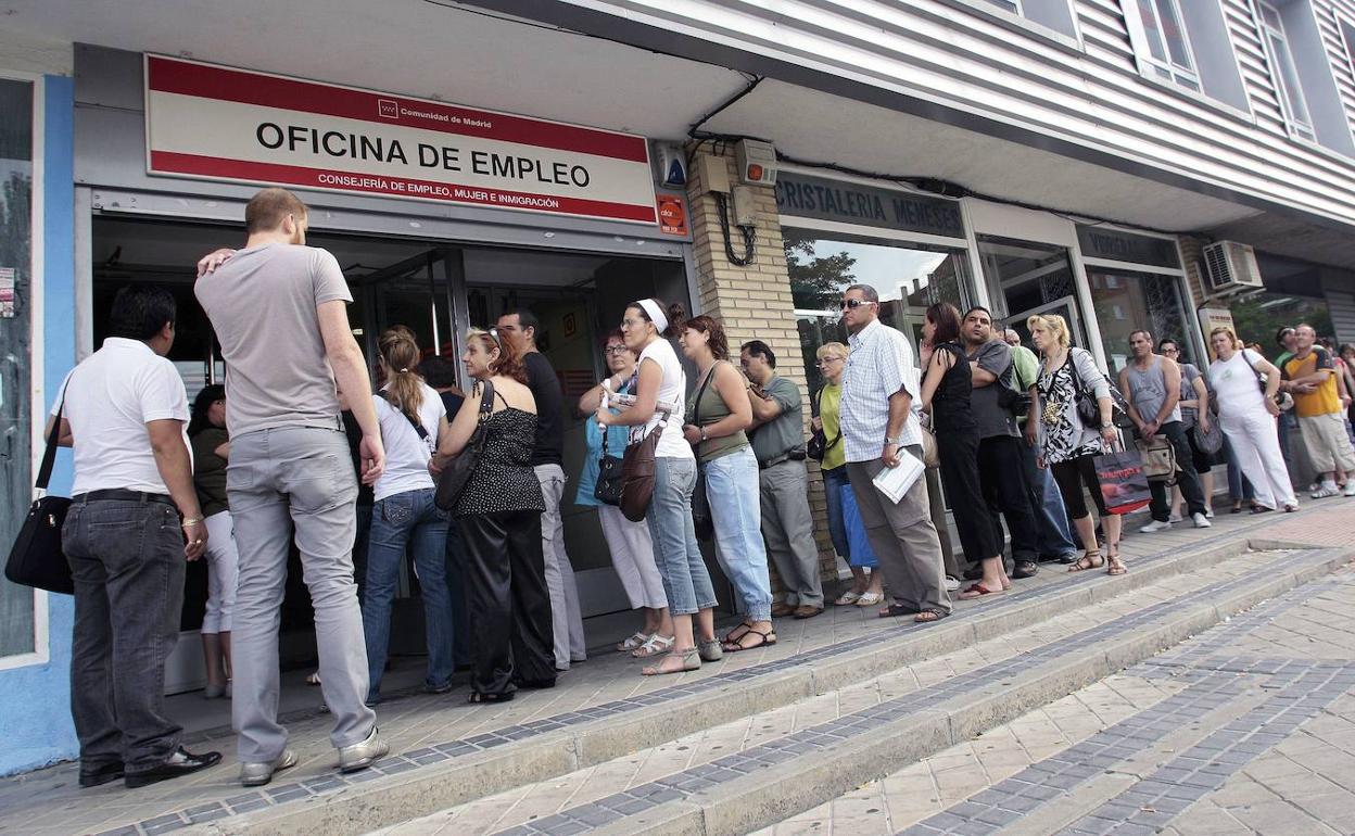 Personas haciendo cola a las puertas de una oficina de empleo. 