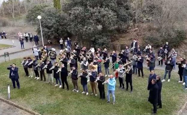 Los integrantes de la agrupación tocan una marcha ante la ventana de su compañero en el hospital leonés.