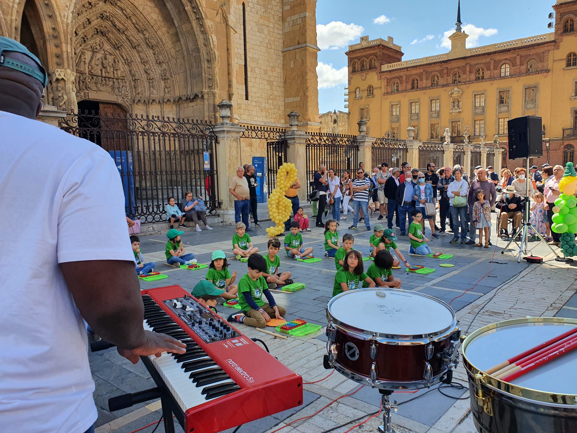 Música solidaria a los pies de la Catedral. Los pequeños alumnos de '+QMÚSICA' han sacado sus instrumentos en la plza de la Regla para mostrar las acciones sociales que realiza la Sociedad de San Vicente de Paúl.