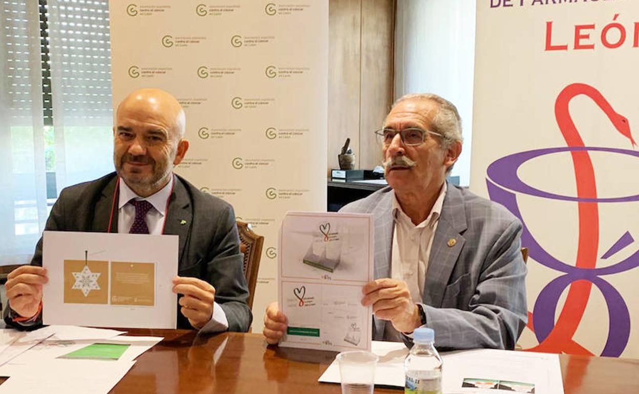 Estanislao de Luis Calabuig, presidente de la Asociación Española Contra el Cáncer en León, y Javier Herradon Muñoz, presidente del Colegio Oficial de Farmacéuticos de León, mostrando los adornos navideños qeu se venderán para la nueva campaña contra el cáncer. 