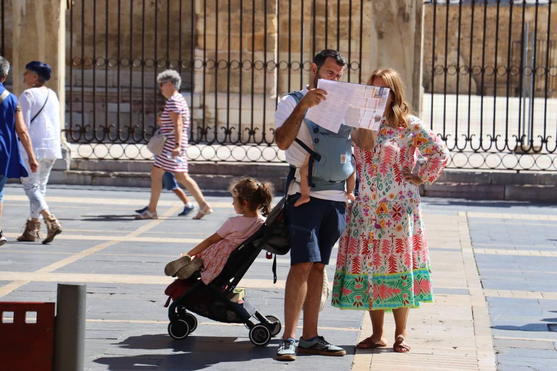 Una familia estudia el mapa de la ciudad en la plaza de Regla.