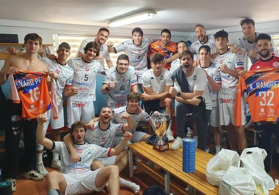 Los jugadores de Ademar posan con el trofeo en el vestuario.