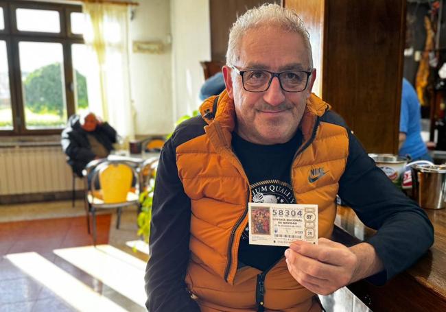 César Martínez con su décimo en la barra del bar Austral.