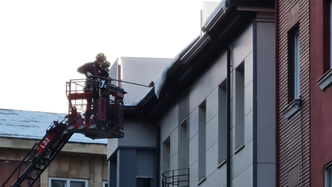 Bomberos interviene para retirar el hielo formado en varias viseras de nieve en inmuenbles de León. Efectivos del parque de Bomberos de León han intervenido para retirar la nieve de la techumbre de un inmueble en García I de la capital. 