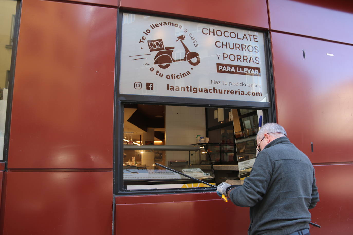 Los trabajadores de la churrería La Antigua colocan el local después del intento de robo.