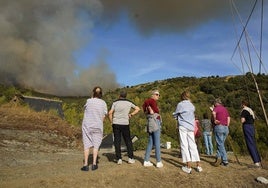 Varios vecinos observan con impotencia el humo procedente del incendio desde Tremor de Abajo.