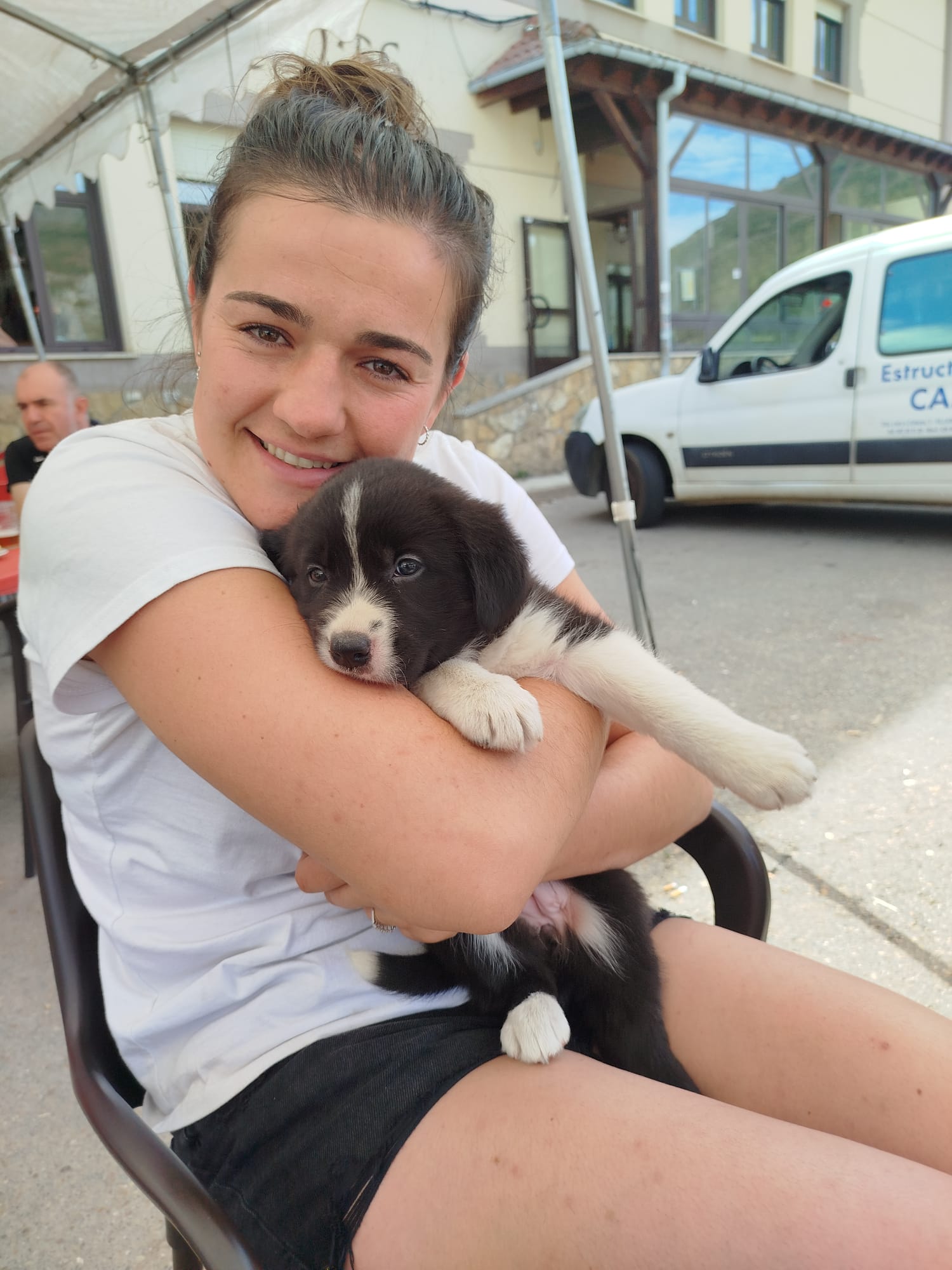 Andrea abraza a Sansa en su primer día juntas. Aquí están en Villaquilambre cuando la perrita tenía mes y medio.
