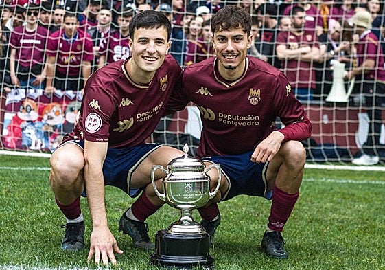 Samu Mayo (D), junto a su compañero en el Pontevedra Rares Mezdrea (I), posa con el trofeo de campeones del grupo 1 de Segunda RFEF.