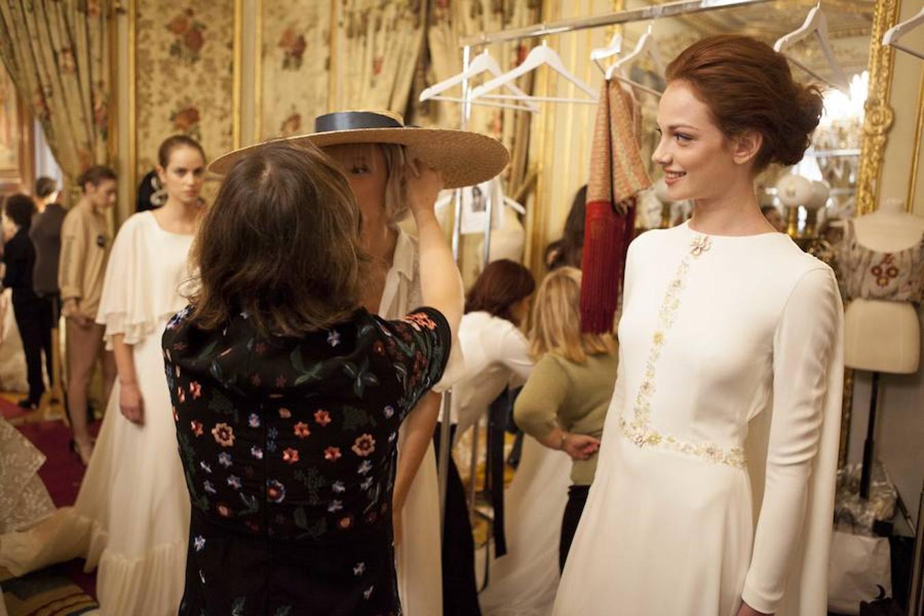 Los diseñadores y su equipo se ocupan de los últimos detalles para que las modelos estén perfectas en el desfile de Novias Couture.