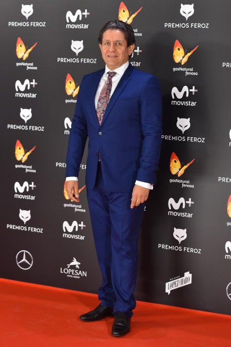 El veterano actor con traje azul y corbata años '90.