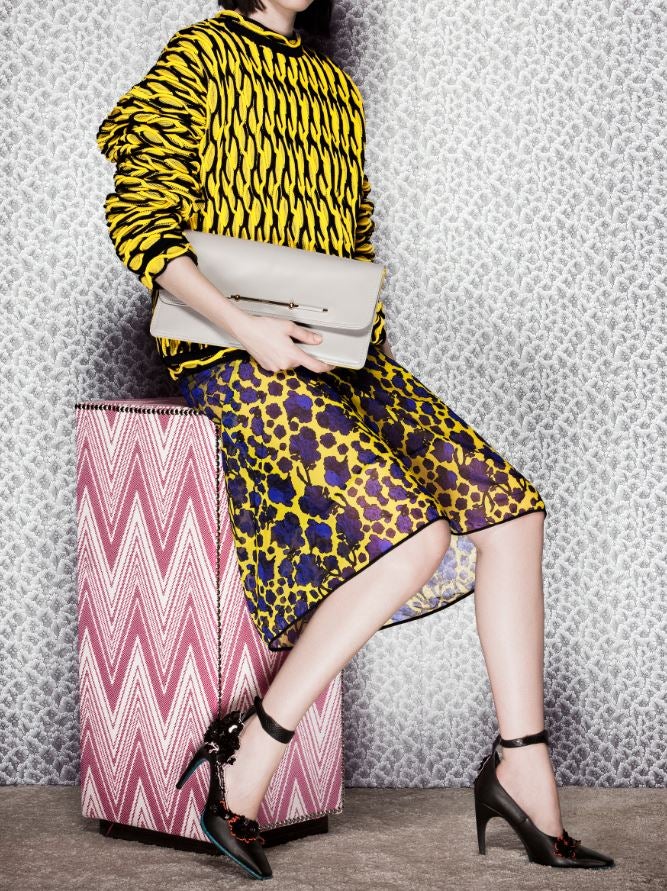 Total look" formado por jersey, falda, bolso y zapatos de Versace. La butaca es de Gastón y Daniela.