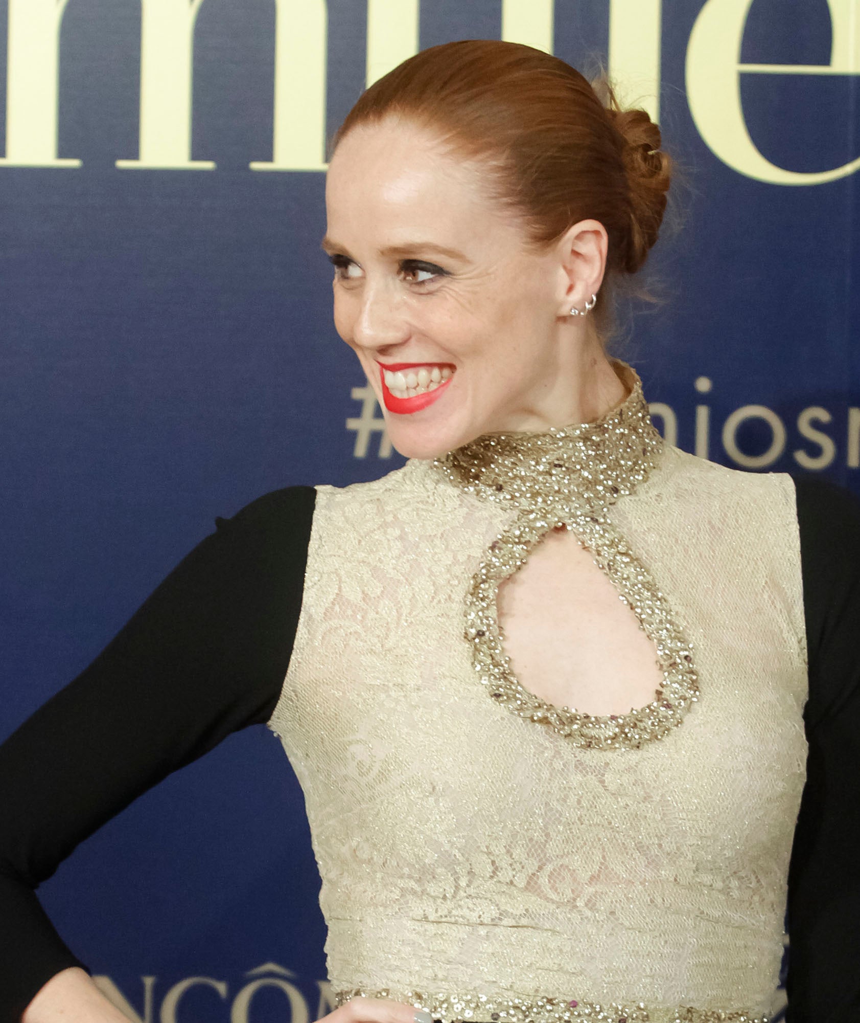 María Castro con moño de bailarina pulido en las raíces, eyeliner negro y labios rojos mates.