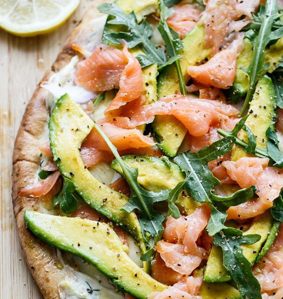 Pizza de aguacate, rúcula y salmón ahumado.