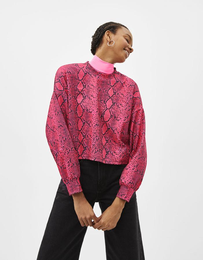 Sudadera "cropped" con estampado de serpiente, cuello "perkins" y manga ancha (17,99 euros).
