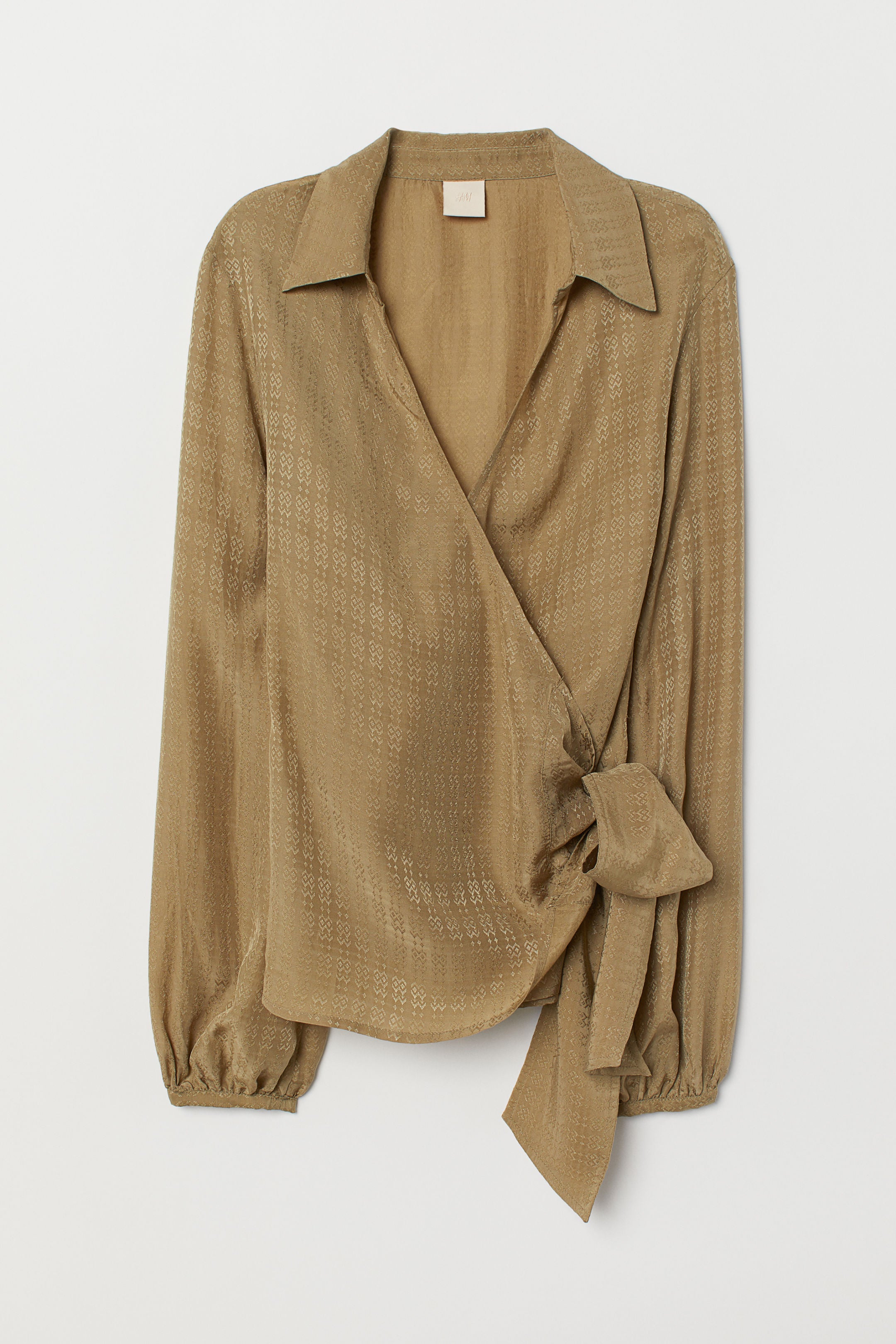 Blusa cruzada con bordados: 29,99 euros en H&M.