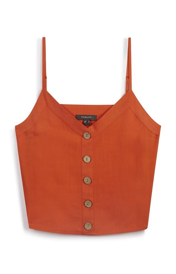 Camiseta de tirantes de lino en color naranja, 9 euros.