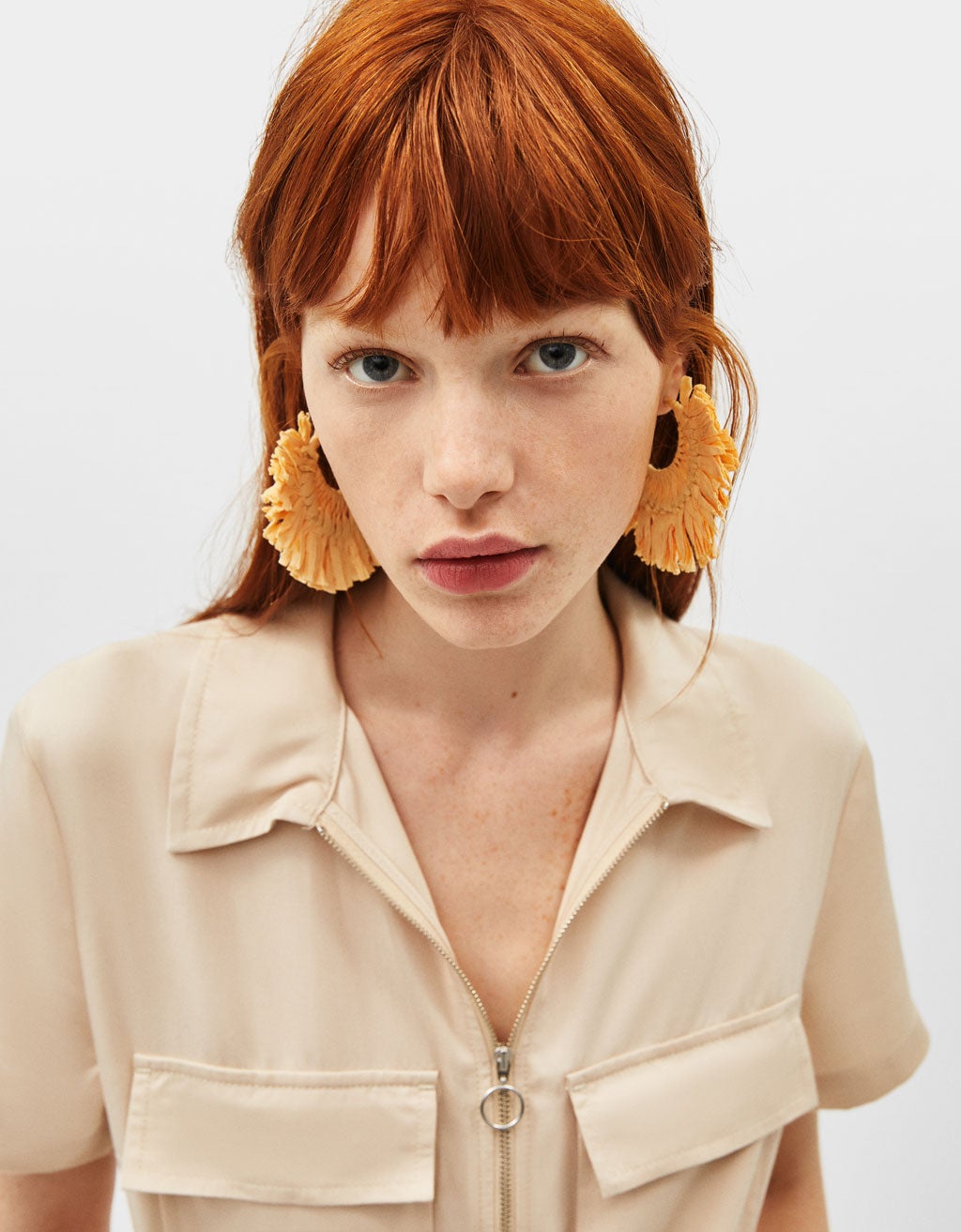 Pendientes de rafia (pura tendencia) en tono amarillo pastel. El resultado: un look ultra primaveral con el que conseguirás presumir de estilazo. (6,99 euros).