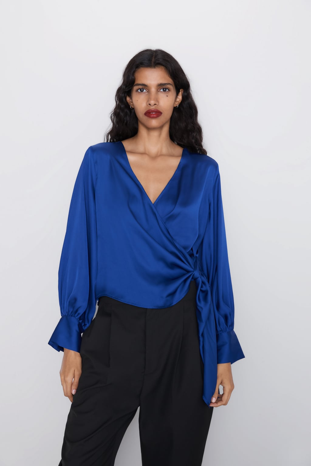 Blusa satinada de escote pico y manga larga acabada en puño ancho: 22,95 euros en Zara.