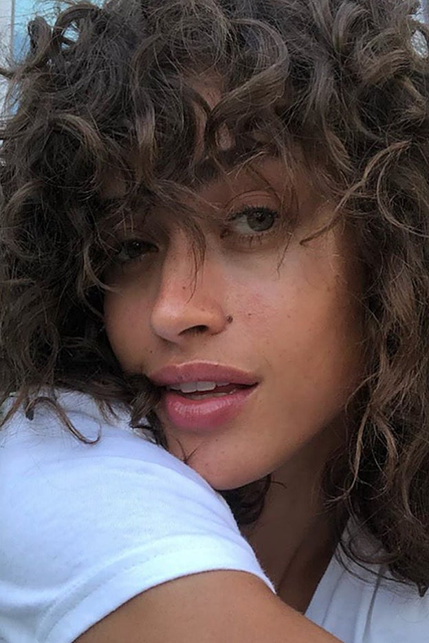 El corte de máxima tendencia para pelo rizado lo lleva la modelo Alanna Arrington: con flequillo.