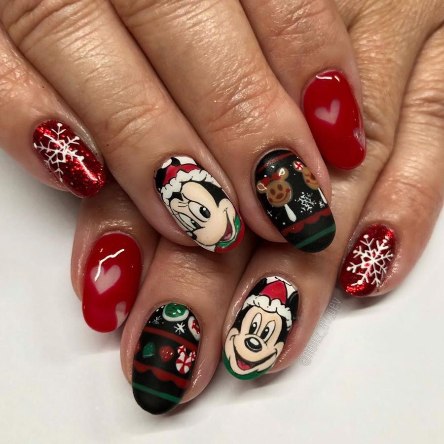 Con Disney como inspiración, este look de uñas navideño en tonos rojos tiene a Mickey y Minnie como protagonistas, aunque nos gustan especialmente las de fonod negro con motivos navideños.