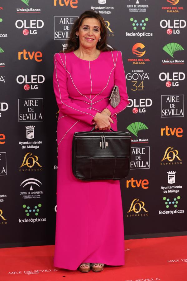 ¿Doble bolso? Un 'clutch' plateado y un maletín negro para acompañar un vestido rosa.