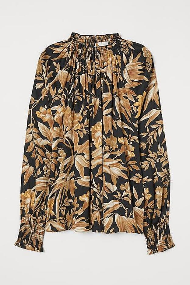 Elegantísmo estampado de hojas dorado sobre fondo negro.