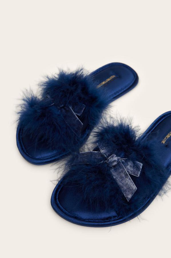 Una de nuestras favoritas son estas zapatillas de estar en casa con detalle de plumas y lacito en el empeine, todo ello en azul intenso. De 17,99 euros han pasado a costar 13,99 euros y están disponibles entre los números 36 y 41.